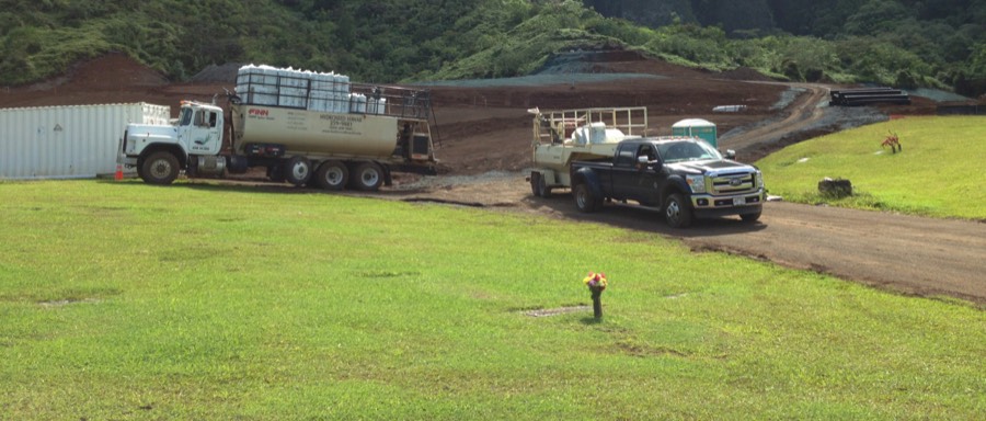 Hawaiian Hydroseeding trucks working a freshly grown green slope